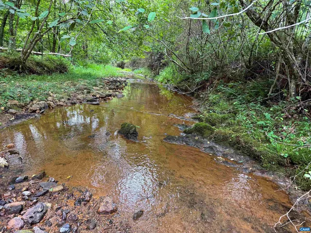 a view of a lake view with houses in background