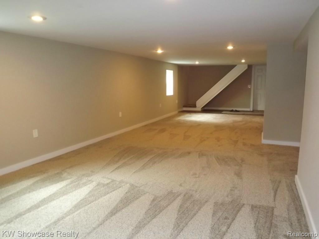 2033 Porter Road White Lake, MI 48383 - Photo 22 of 36 Spacious and open great room in the walkout lower level. Notice all the natural light enhanced with recessed lighting.