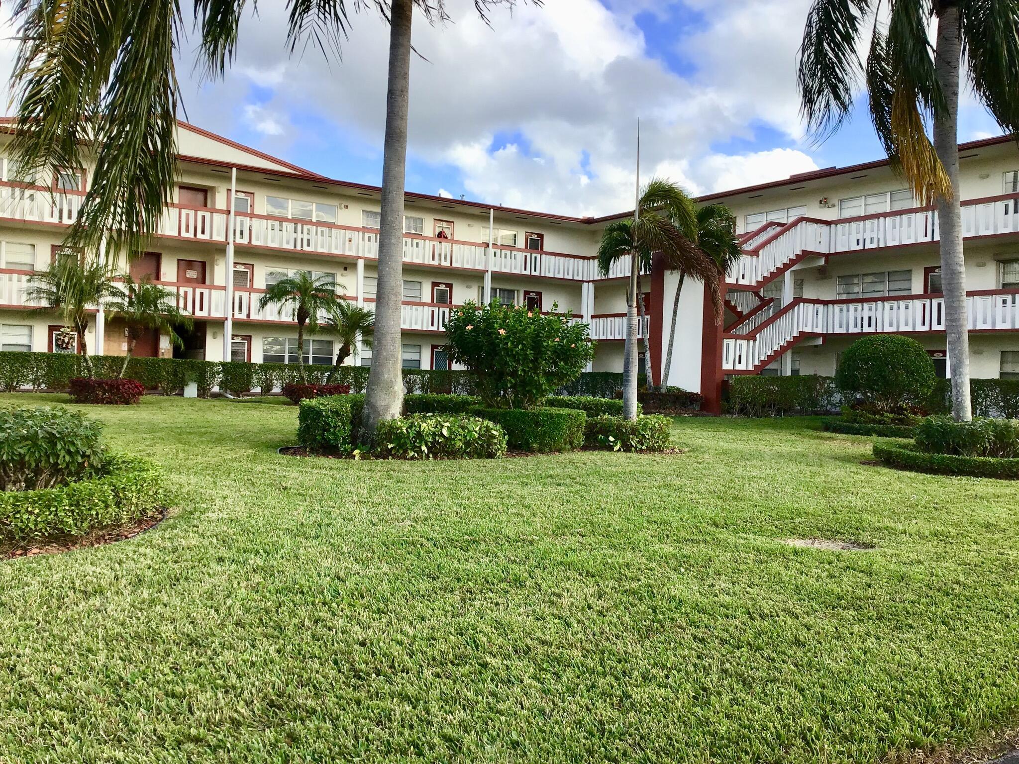 84 Brighton B Boca Raton, FL 33434 - Photo 13 of 35 a view of a building and a yard