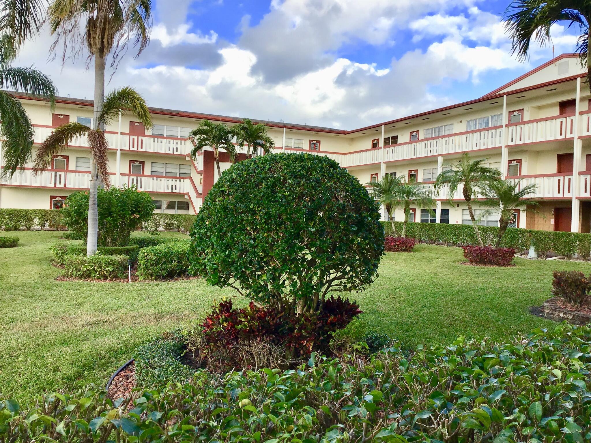 84 Brighton B Boca Raton, FL 33434 - Photo 16 of 35 a view of a garden with a building in the background