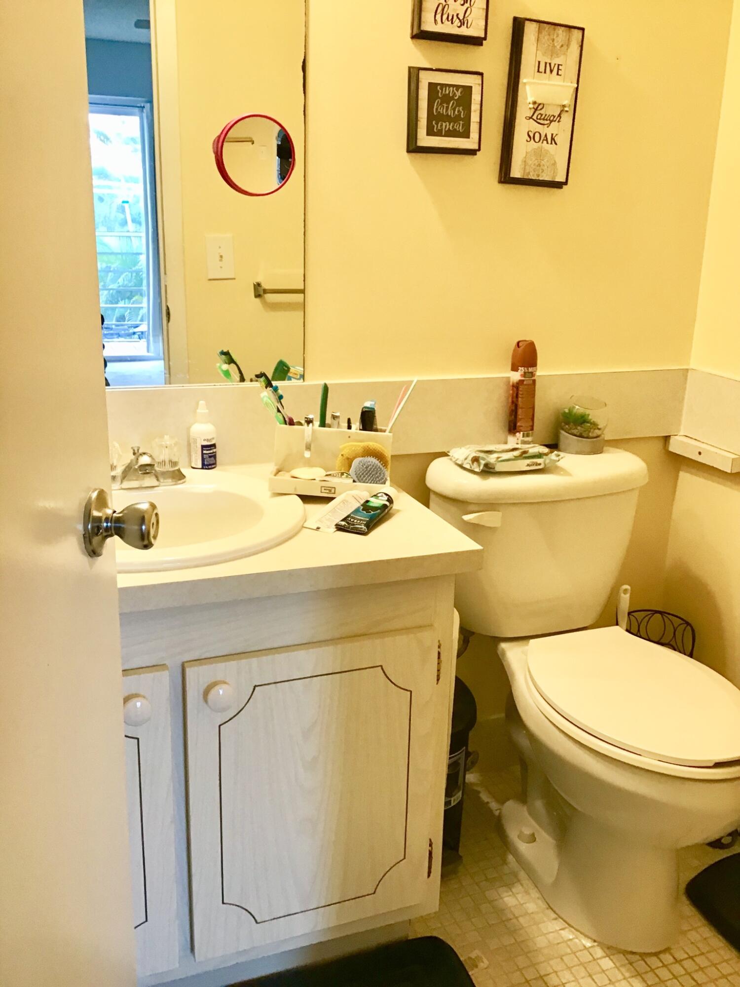 84 Brighton B Boca Raton, FL 33434 - Photo 19 of 35 a bathroom with a sink and a toilet