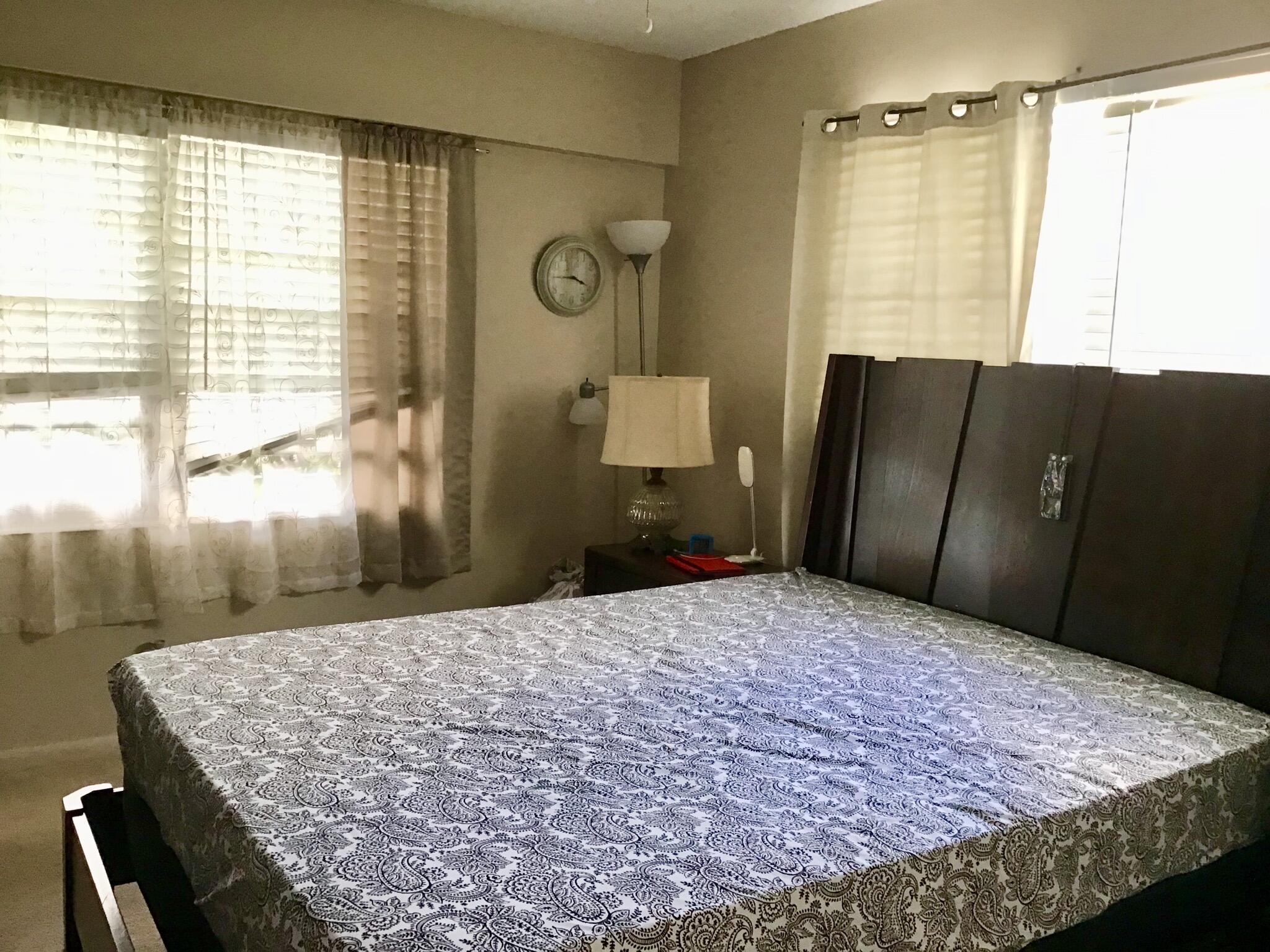 84 Brighton B Boca Raton, FL 33434 - Photo 22 of 35 a bedroom with a bed and a window