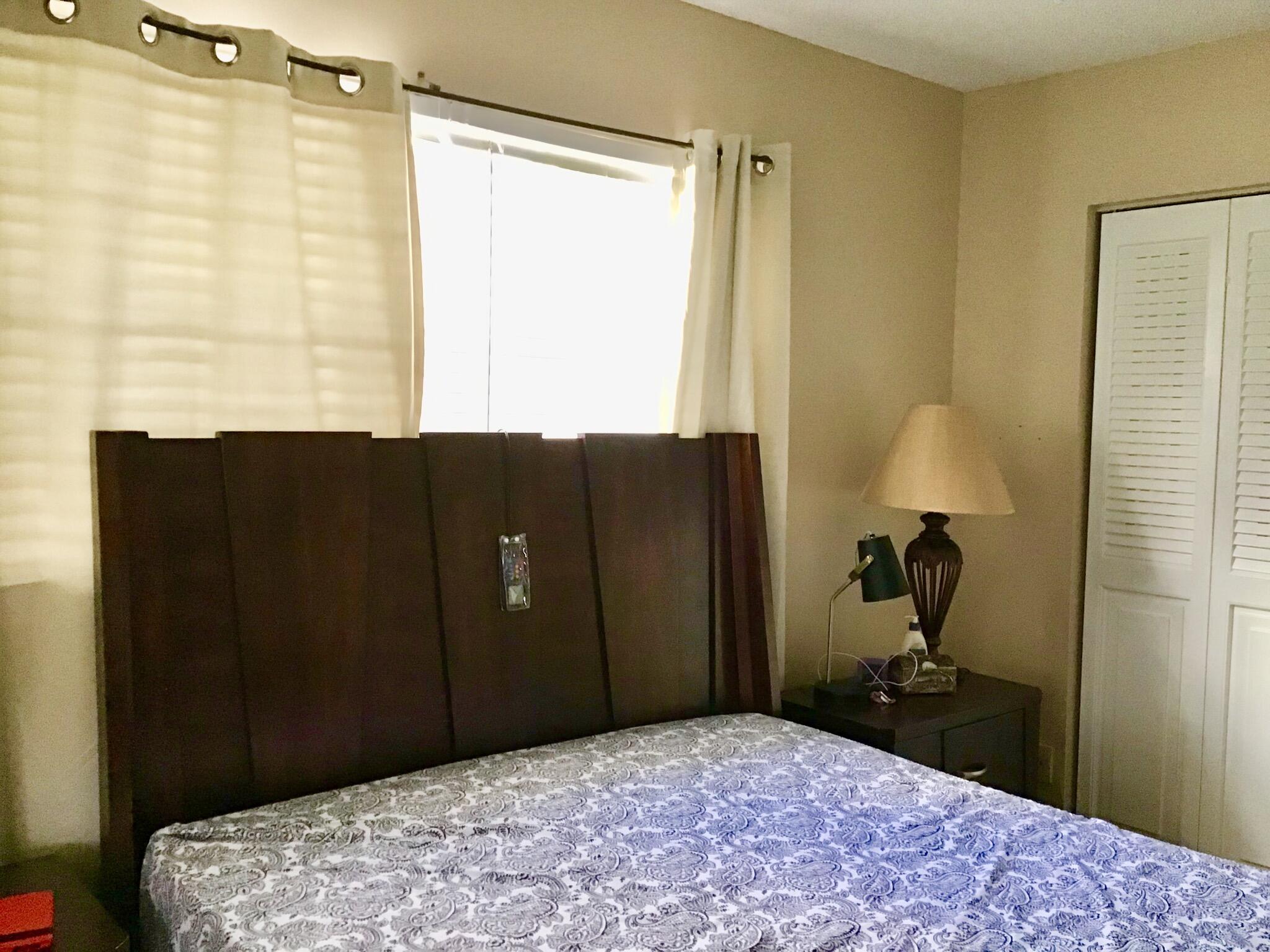 84 Brighton B Boca Raton, FL 33434 - Photo 23 of 35 a bedroom with a bed and a dresser