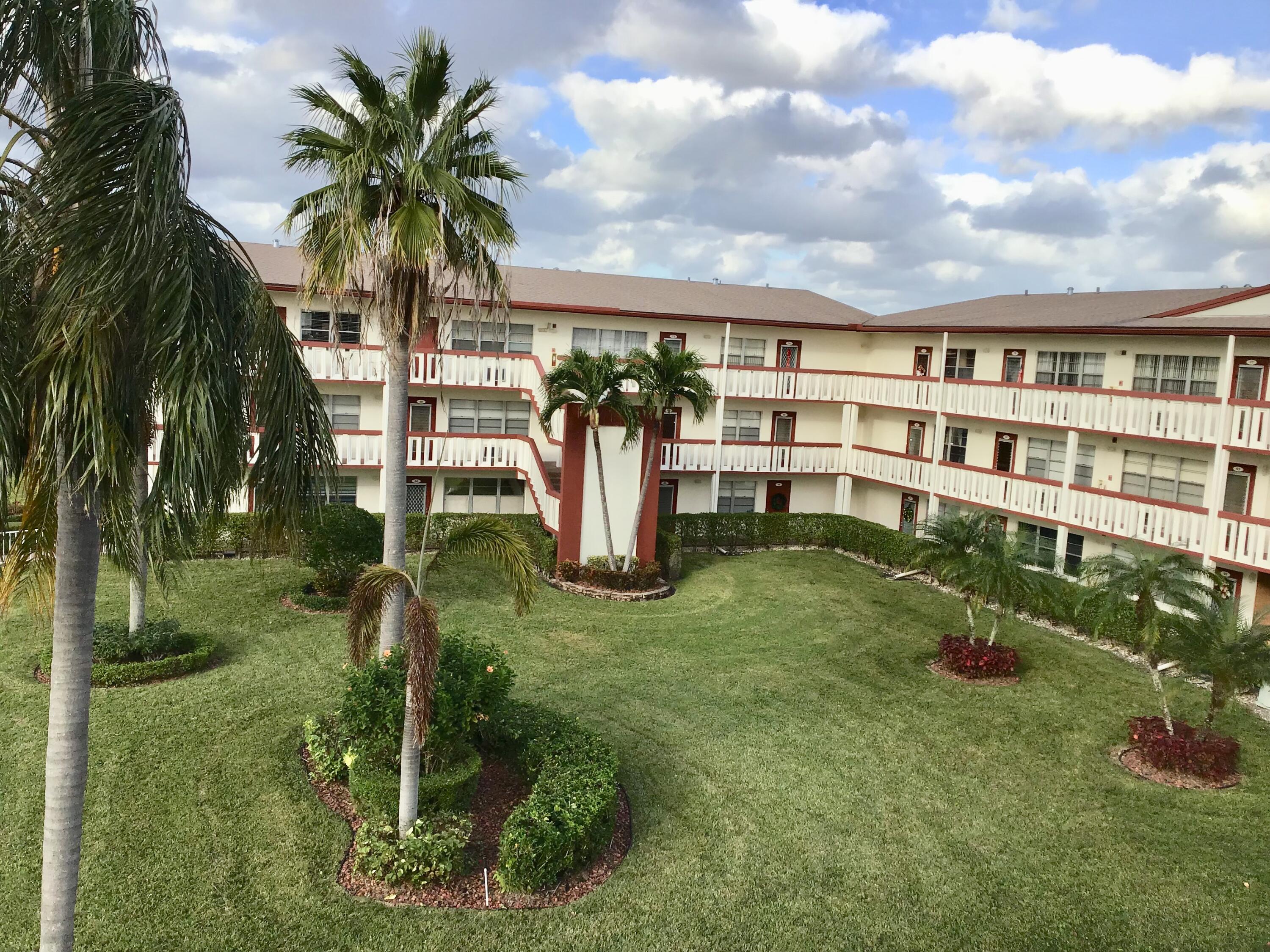 84 Brighton B Boca Raton, FL 33434 - Photo 25 of 35 a view of a house with a yard and potted plants