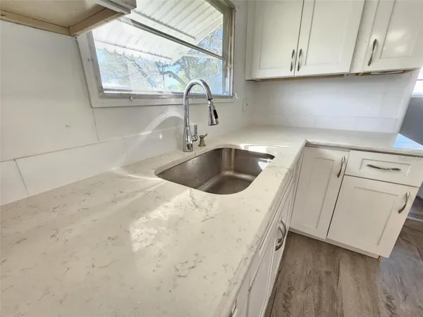 a kitchen with a sink and cabinets