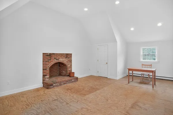 a view of a livingroom with furniture and a fireplace