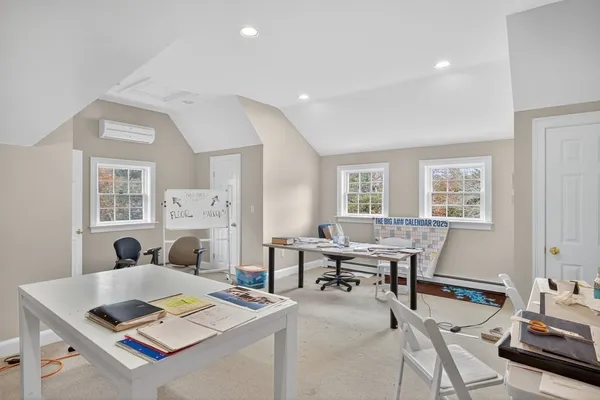 a living room with furniture pool table and windows