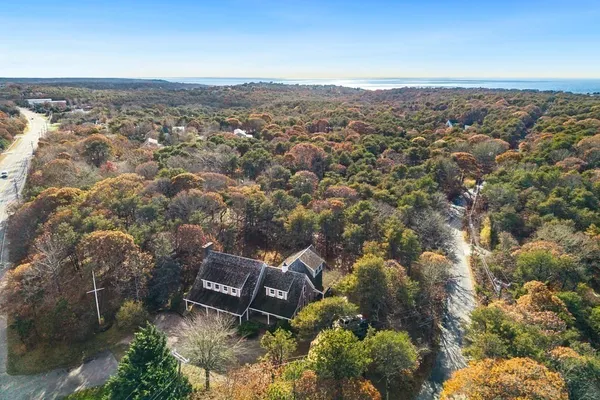 an aerial view of a house with a city