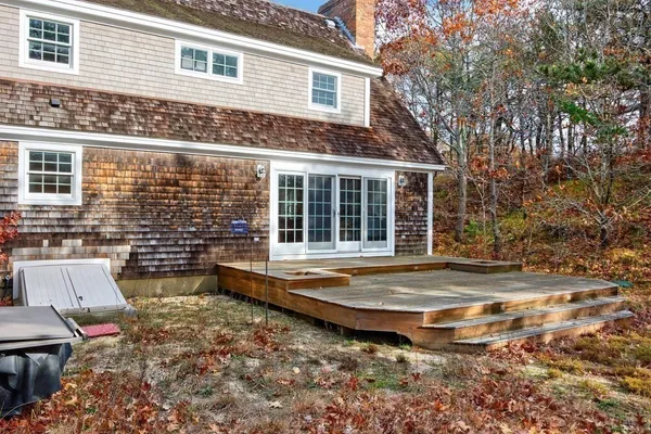 a view of a house with backyard and sitting area