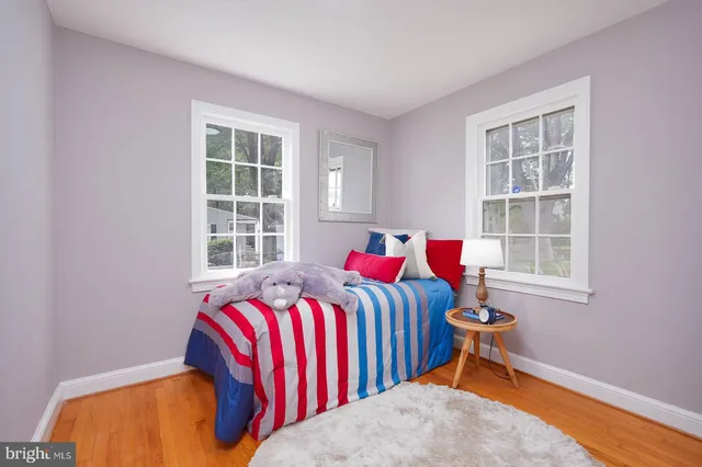 a bedroom with a bed and windows