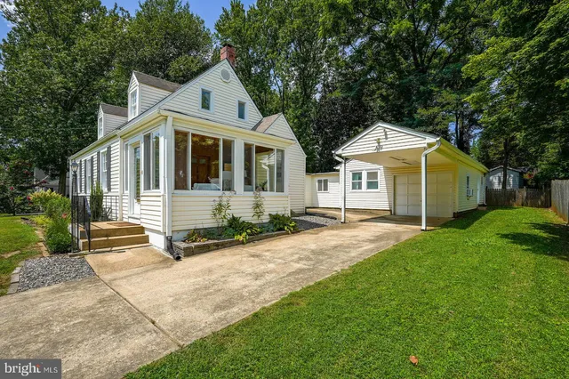 a front view of a house with a yard and porch