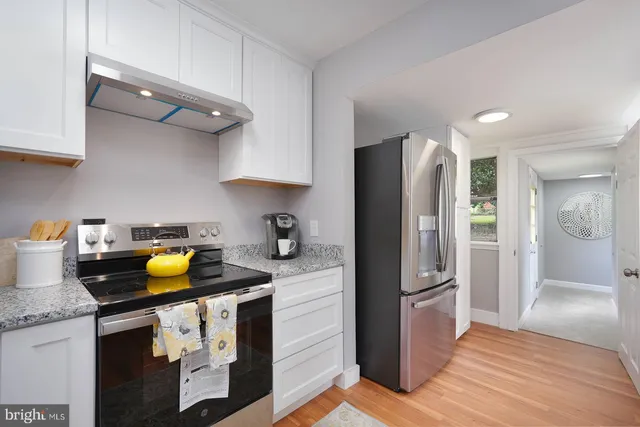 a kitchen with a refrigerator and cabinets