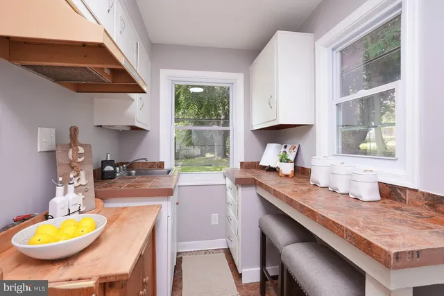 a kitchen with sink a stove and a wooden cabinets