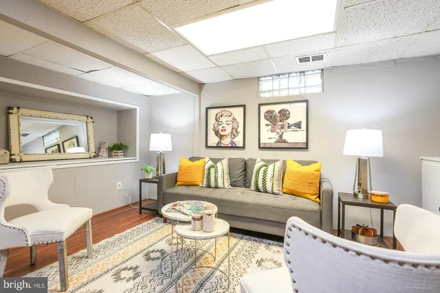 a living room with furniture and painting on the wall