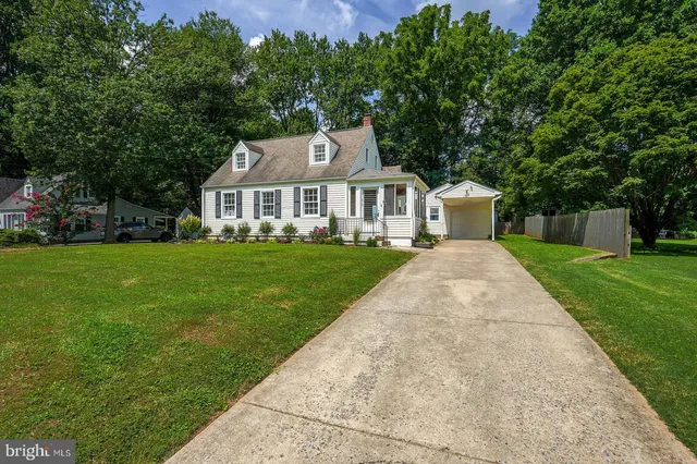 a front view of a house with yard and green space
