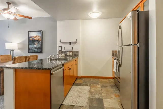 a kitchen with sink refrigerator and window