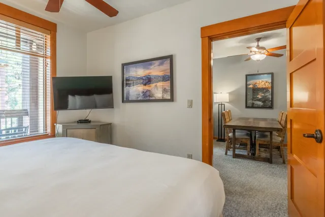 a kitchen with stainless steel appliances granite countertop a refrigerator a stove and a sink with wooden floor