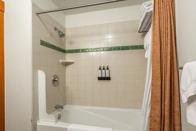 a bathroom with a granite countertop sink mirror and toilet
