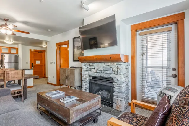 a living room with furniture fireplace and flat screen tv