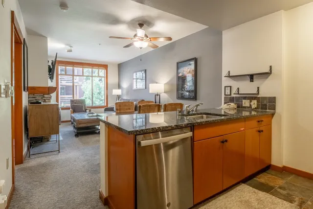 a kitchen with granite countertop a sink and a window