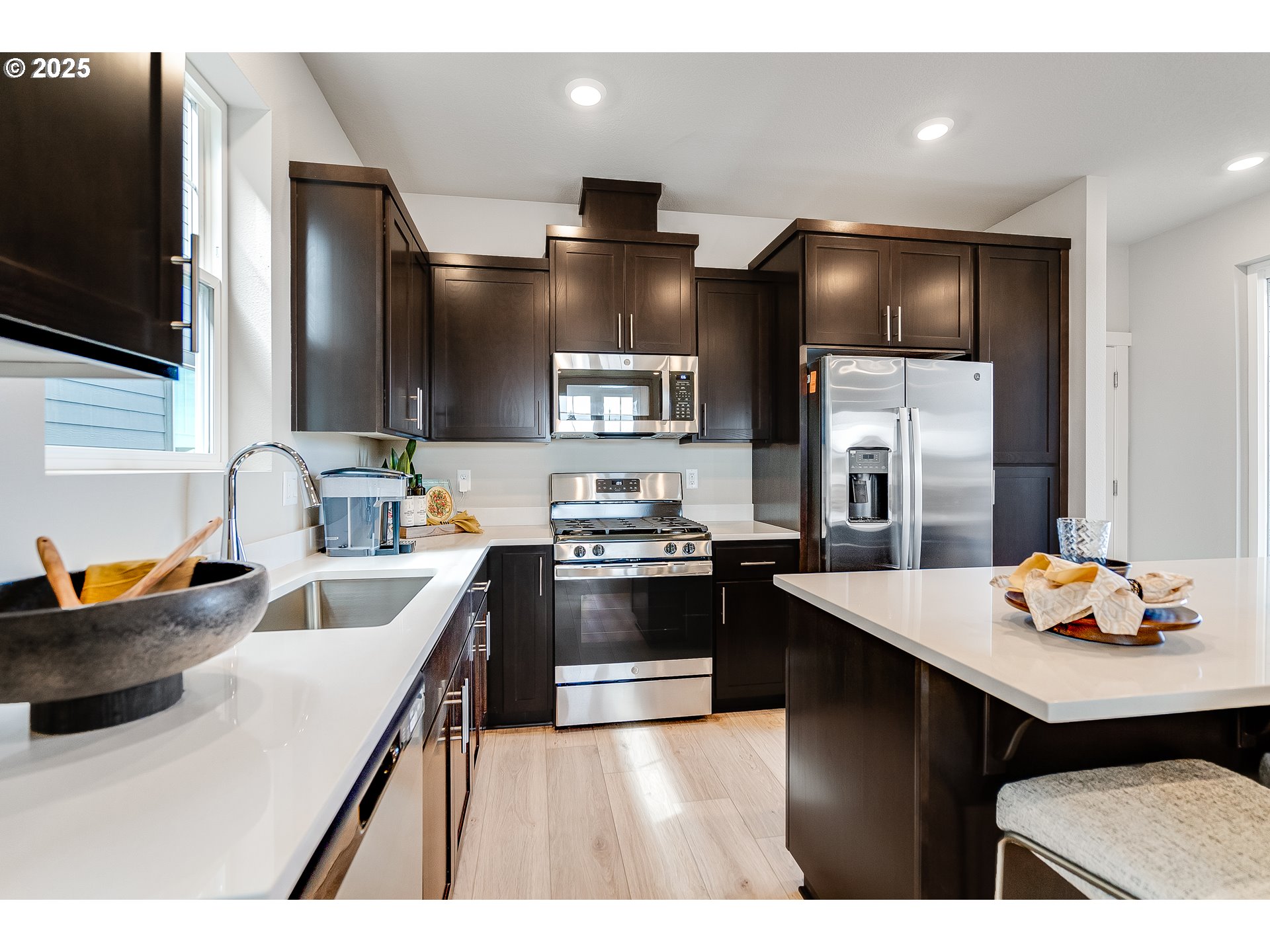 a kitchen with stainless steel appliances a sink stove and refrigerator