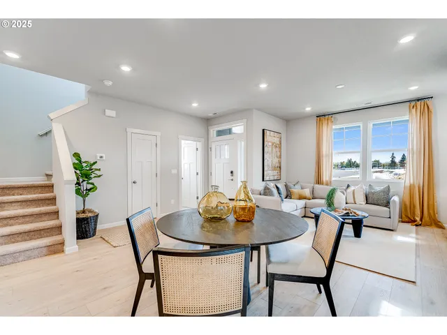 a living room with furniture a rug and a table