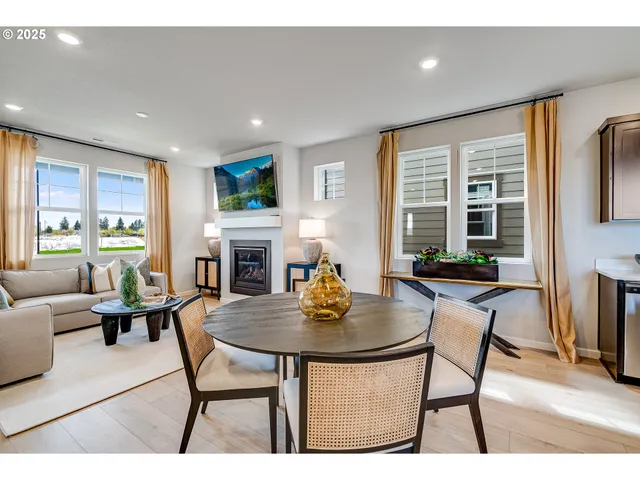a living room with fireplace furniture and a table