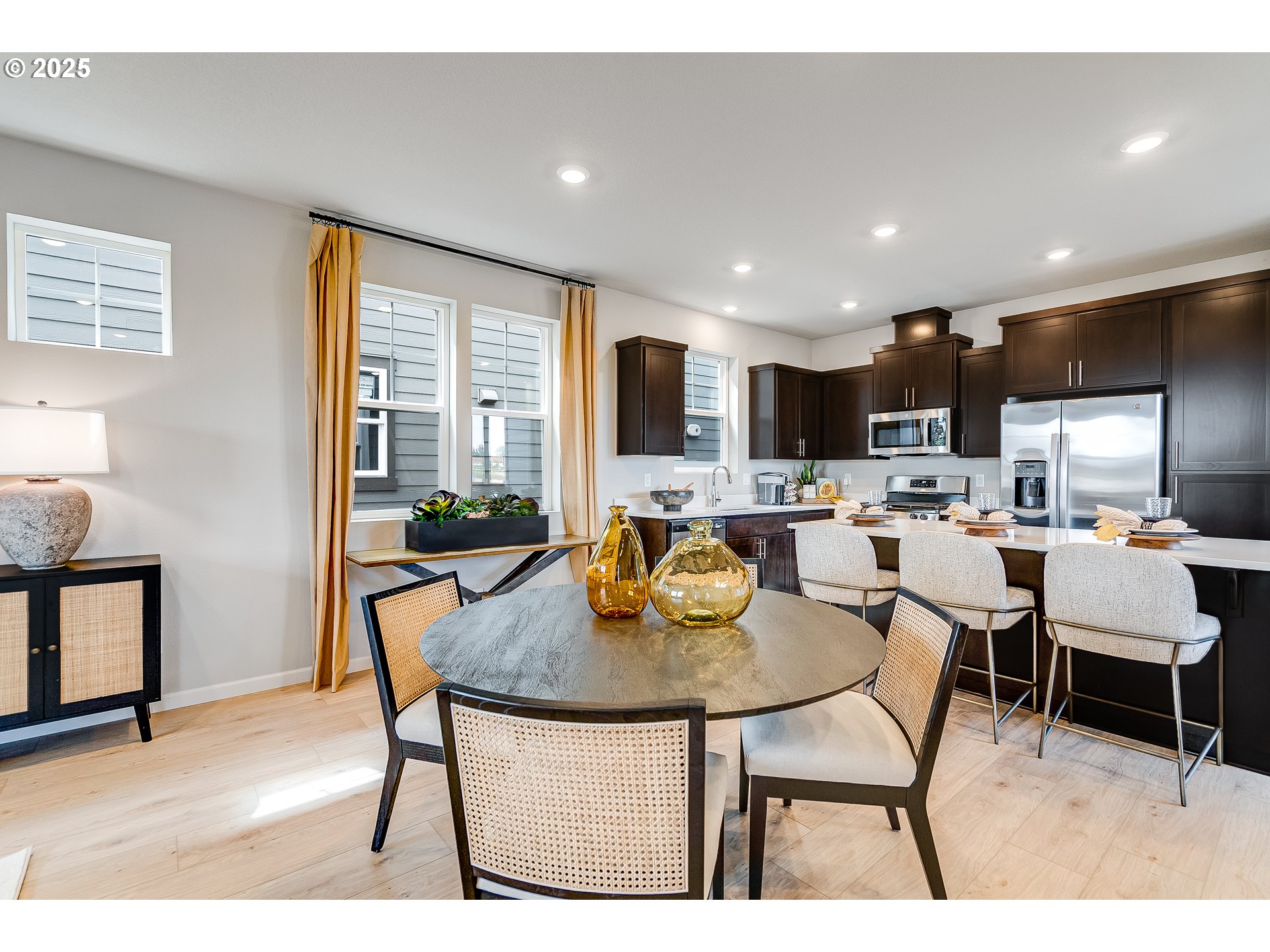 931 Legacy Street Eugene, OR 97402 - Photo 6 of 21 a kitchen with a table chairs refrigerator and cabinets