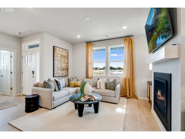 a living room with furniture flat screen tv and a fireplace