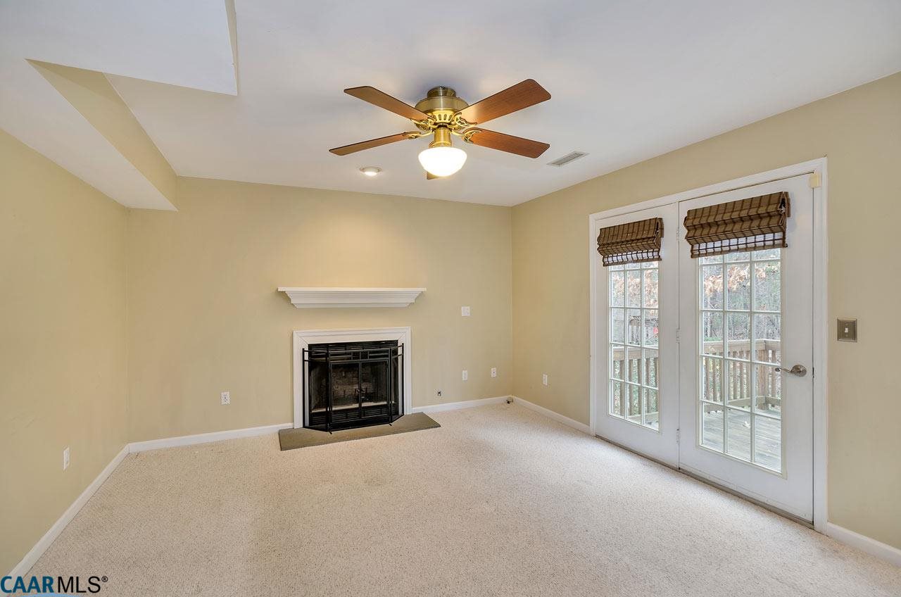 200 Doe Drive Ruckersville, VA 22968 - Photo 5 of 22 a view of a livingroom with a fireplace and fan