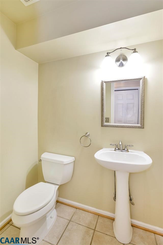 200 Doe Drive Ruckersville, VA 22968 - Photo 6 of 22 a bathroom with a toilet sink and mirror