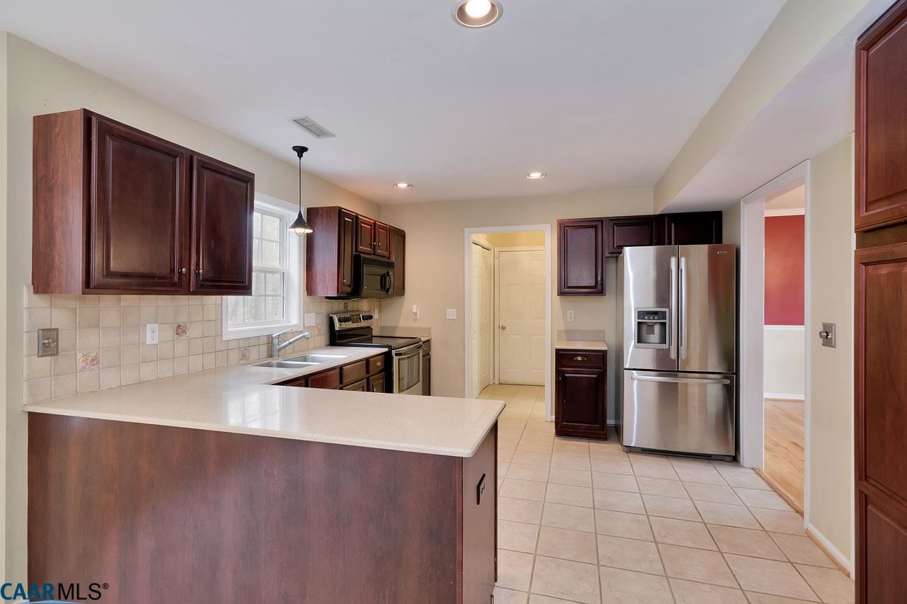 200 Doe Drive Ruckersville, VA 22968 - Photo 9 of 22 a kitchen with stainless steel appliances granite countertop a refrigerator stove and cabinets