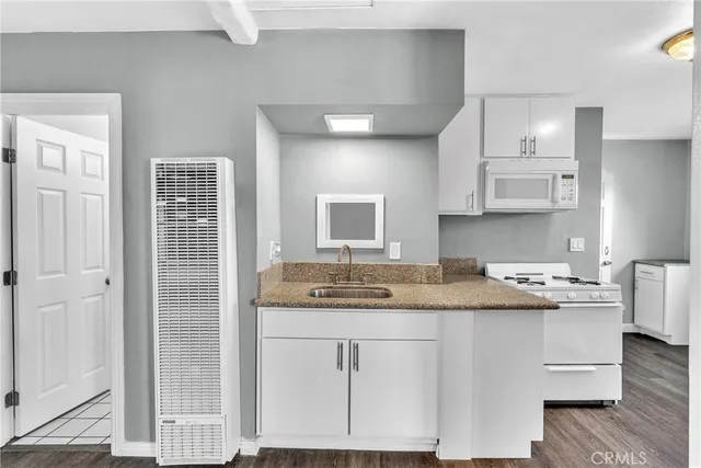 a kitchen with a sink a cabinets and window