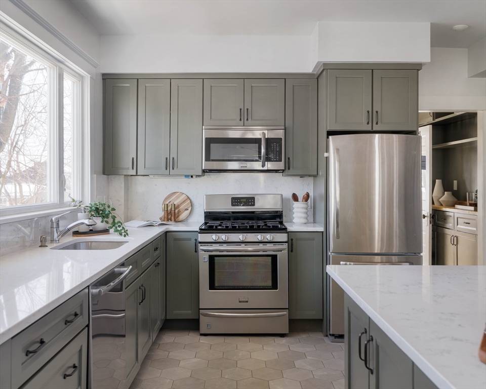 182 Maplewood Street, Unit 2 Watertown, MA 02472 - Photo 15 of 42 a kitchen with cabinets stainless steel appliances and a sink