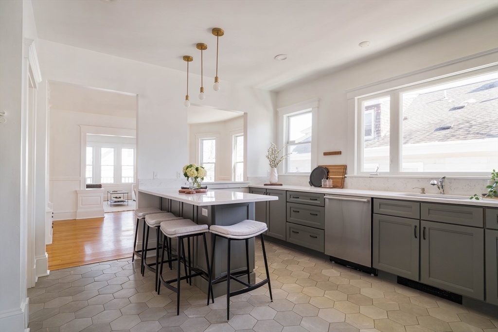 182 Maplewood Street, Unit 2 Watertown, MA 02472 - Photo 16 of 42 a kitchen with a dining table chairs and sink
