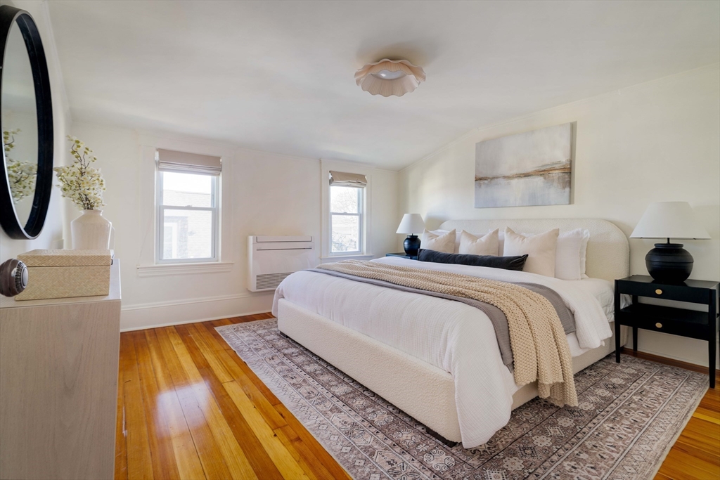 182 Maplewood Street, Unit 2 Watertown, MA 02472 - Photo 23 of 42 a bedroom with a bed and a dresser next to a window
