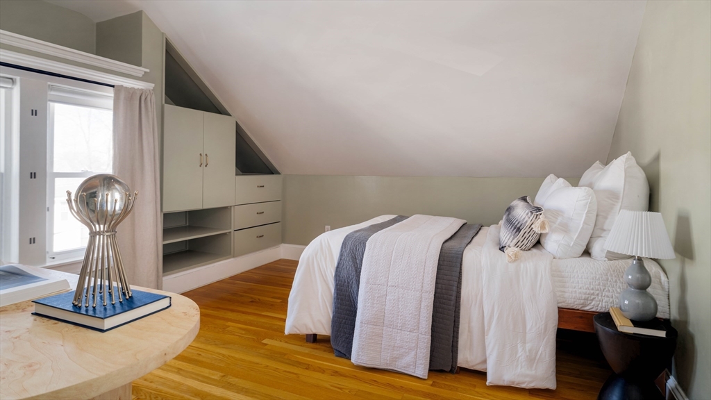 182 Maplewood Street, Unit 2 Watertown, MA 02472 - Photo 27 of 42 a bedroom with a bed and wooden floor