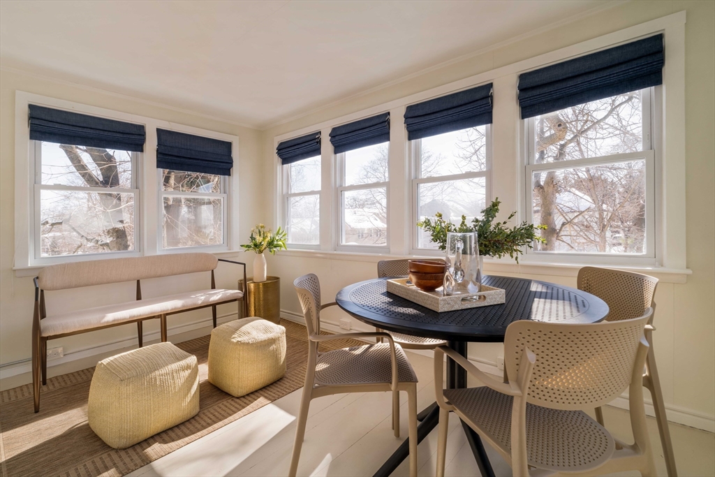 182 Maplewood Street, Unit 2 Watertown, MA 02472 - Photo 30 of 42 a dining room with furniture a large window and a chandelier