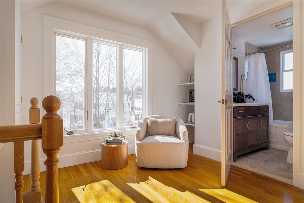 182 Maplewood Street, Unit 2 Watertown, MA 02472 - Photo 32 of 42 a living room with furniture and a floor to ceiling window