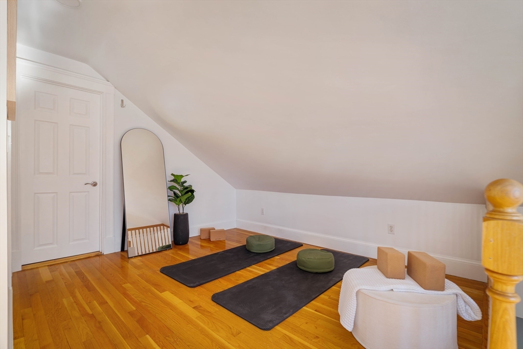 182 Maplewood Street, Unit 2 Watertown, MA 02472 - Photo 34 of 42 a bedroom with a bed and potted plant on the dresser