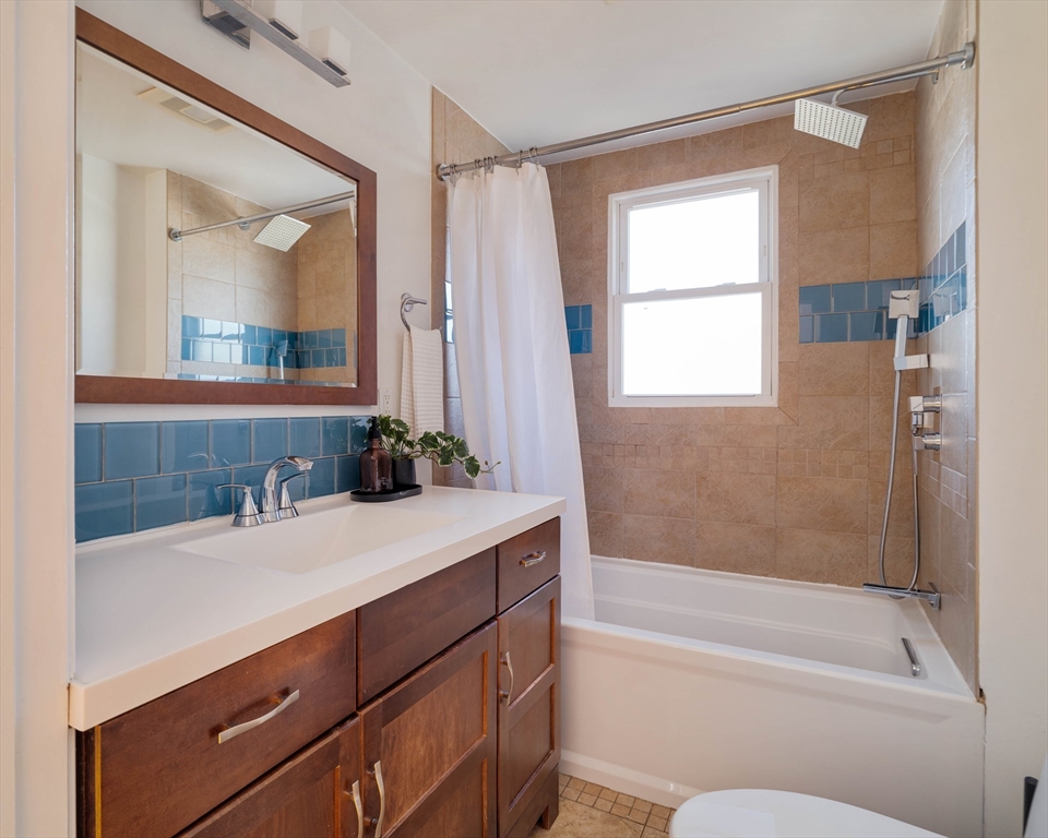 182 Maplewood Street, Unit 2 Watertown, MA 02472 - Photo 36 of 42 a bathroom with a granite countertop sink toilet and shower