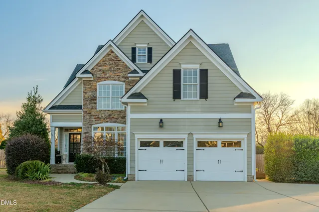 a front view of a house with a yard and garage