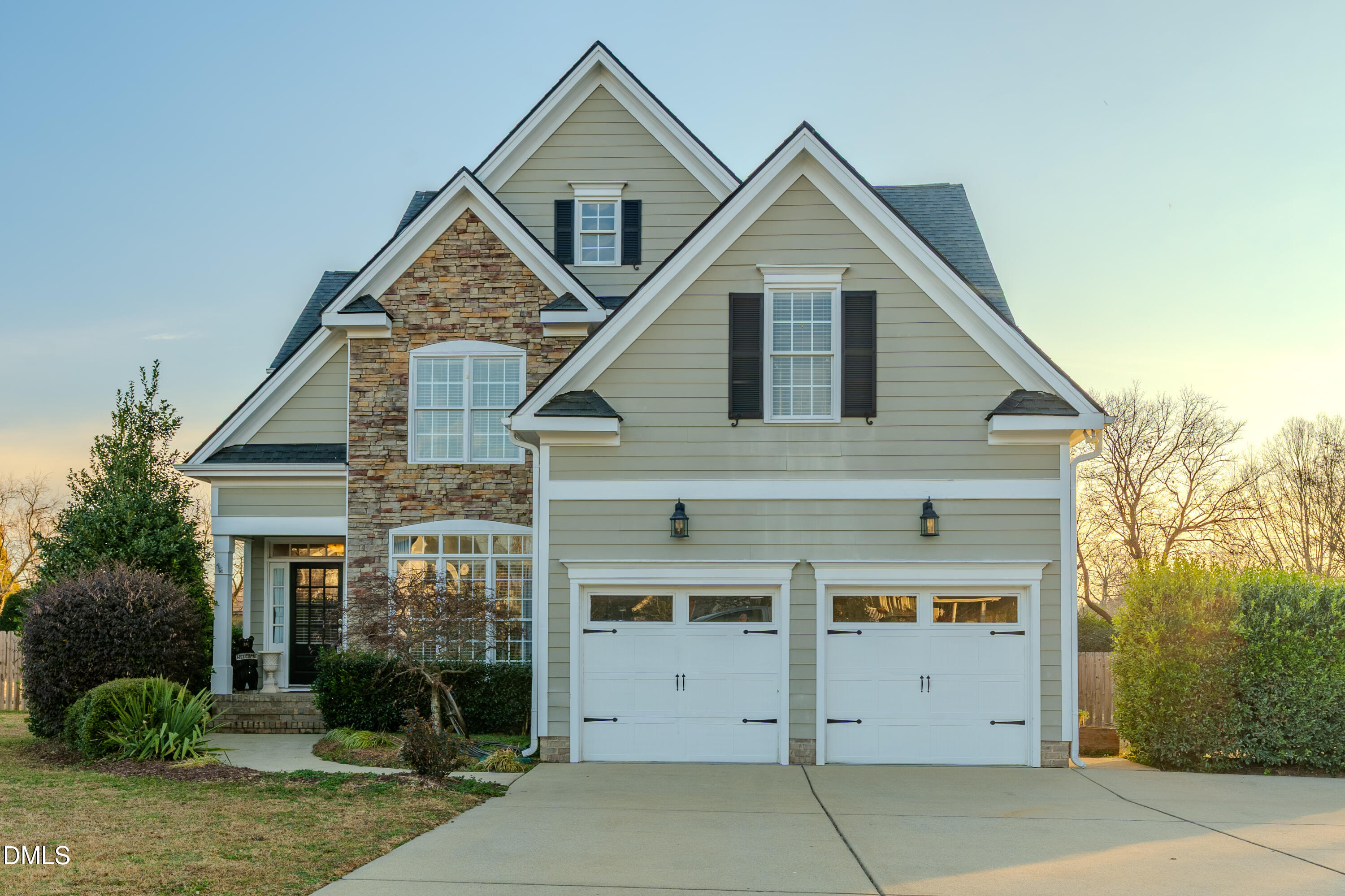 a front view of a house with a yard and garage