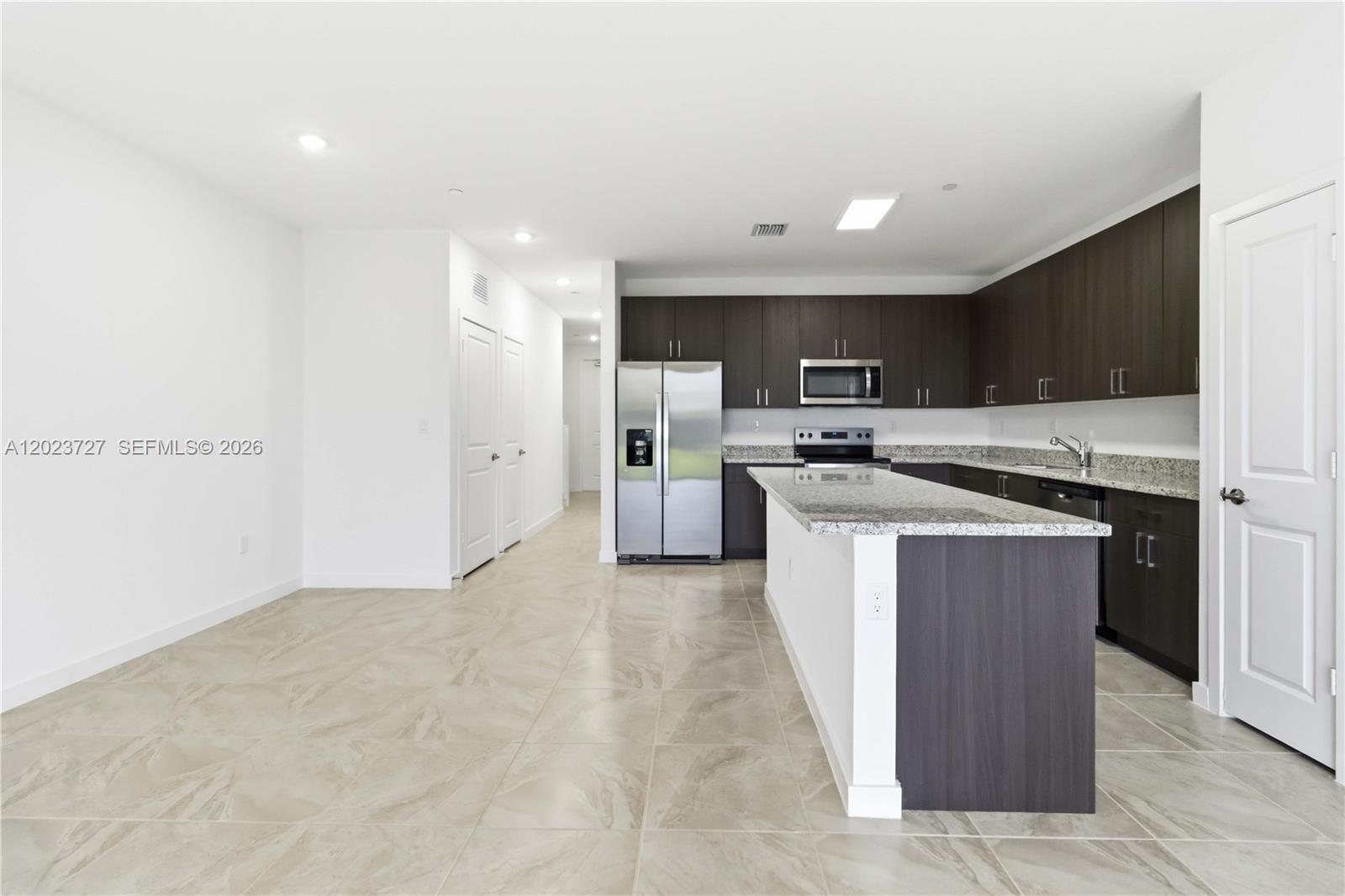 22348 Southwest 115th Court, Unit 22348 Miami, FL 33170 - Photo 7 of 37 a kitchen with cabinets and stainless steel appliances