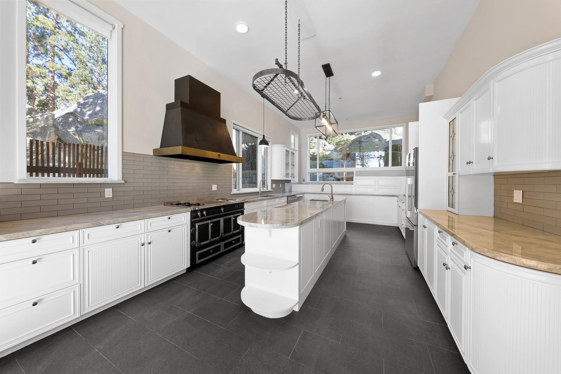 77 Speedboat Avenue Brockway, CA 96143 - Photo 12 of 28 a large kitchen with stainless steel appliances kitchen island granite countertop a sink a stove a counter space and cabinets