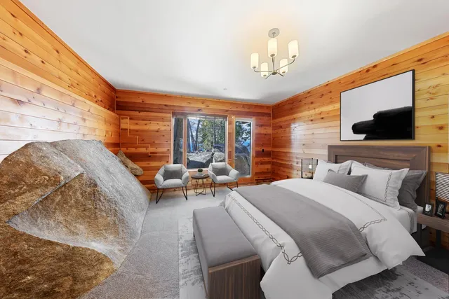 a bedroom with bed and a large window