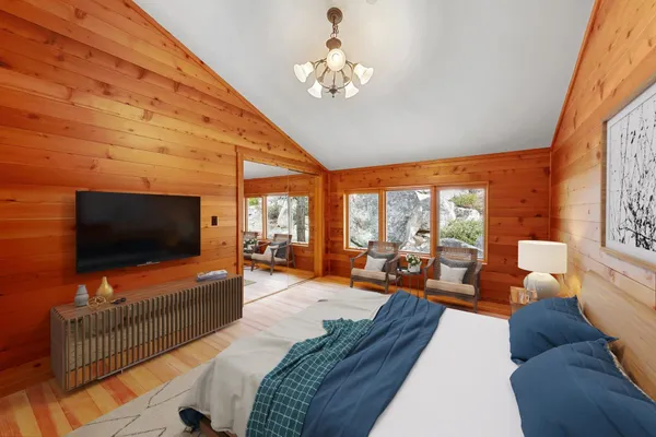 a bedroom with a large bed and a large window