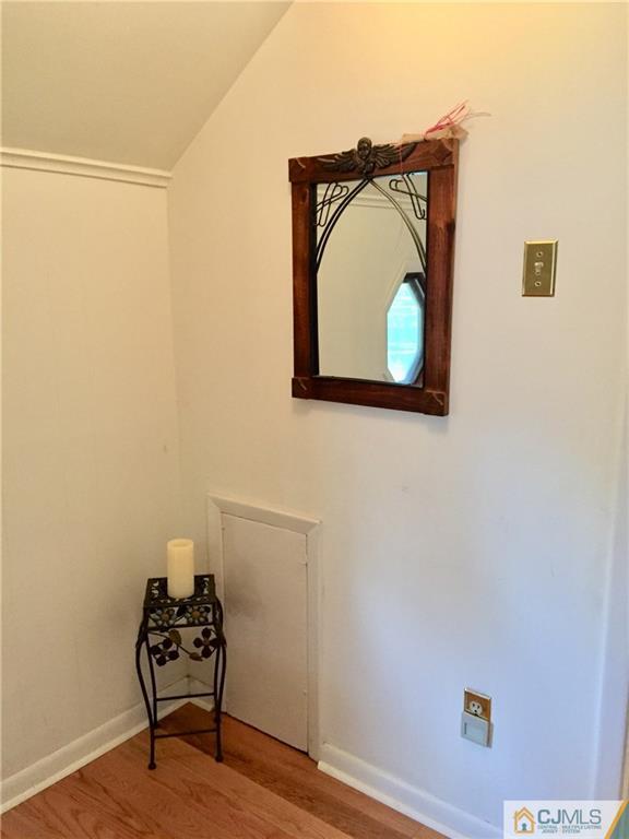 387 Middle Road Hazlet, NJ 07730 - Photo 12 of 20 a living room with a wooden floor and a wall painting