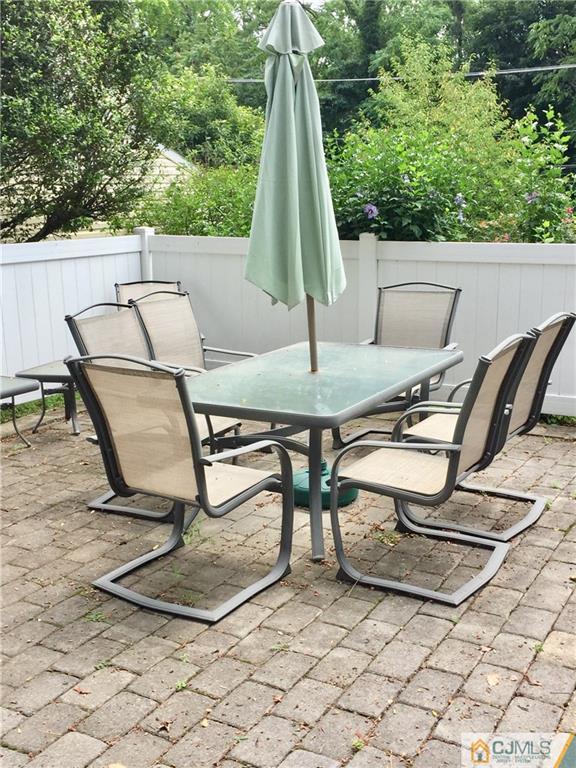 387 Middle Road Hazlet, NJ 07730 - Photo 19 of 20 a view of backyard with a table and chairs