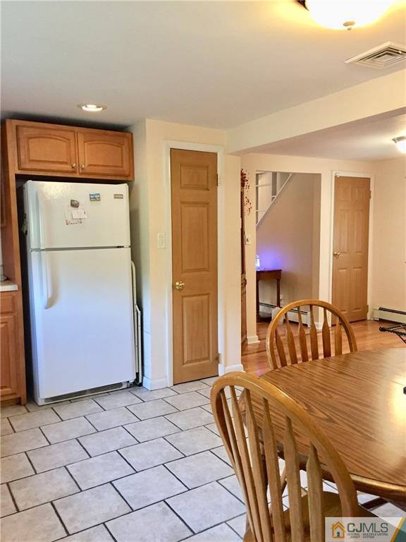 387 Middle Road Hazlet, NJ 07730 - Photo 4 of 20 a bedroom with a bed and a refrigerator